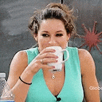 Celebrity gif. Water explodes from actress Jennifer Lawrence's mouth in a spit-take as she tries to drink water from a white mug on a live panel.  