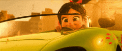 Disney gif. Closeup of Vanelope in Wreck it Ralph behind the wheel of a convertible with her ponytail blowing in the wind and a smug grin on her face as debris flies around her.