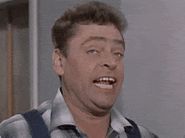 Video gif. Man with expressive blue eyes makes a derpy face before exaggerating his shocked reaction to something. His eyebrows raise higher, his eyes keep widening, and his jaw drops lower and lower.