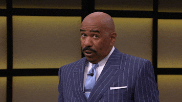 TV gif. Steve Harvey on Steve Harvey TV. He leans back and stares at something for a moment before showing all his teeth and chuckling.