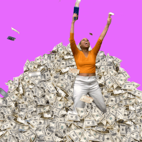 Video gif. Woman dances in a pile of money as she sprays bills from a cash cannon. She gazes up euphorically as it rains down from the fuchsia background behind her.
