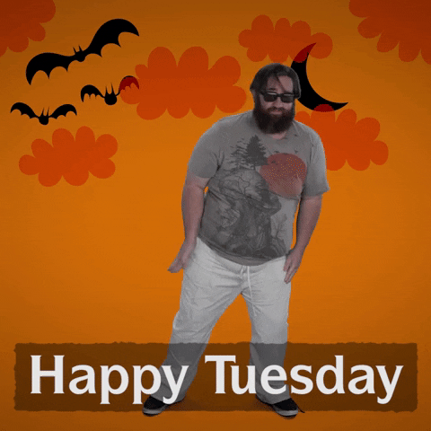 Video gif. In front of an orange-yellow backdrop with illustrations of orange clouds, black bats, and a black crescent moon, a bearded man in sunglasses, a gray t-shirt, and white pants busts some moves vaguely reminiscent of Thriller. Text, "Happy Tuesday."
