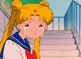 Anime gif. Usagi from Sailor Moon sitting on steps and crying with comically small eyes.