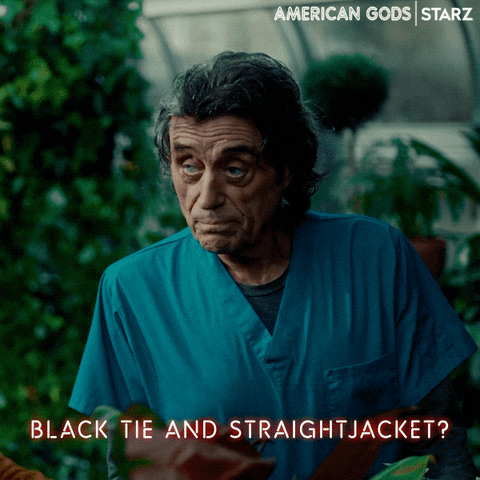 TV gif. Ian McShane as Mr. Wednesday in American Gods, dressed in scrubs, is looking to the side as he asks, "black tie and straightjacket?" which appears as text.