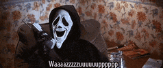Movie gif. Ghostface from Scream in the parody movie Scary Movie sits on chair cackling into a phone and it quickly cuts to three other scenes of people also on the phone, sticking their tongues out. Text, "Wazzzuuuppp."