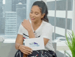 Reality TV gif. Nessa from Talk Stoop puts her head in her hands, looking embarrassed.