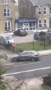 Motorist With Umbrella Fights Skateboarder Outside London School
