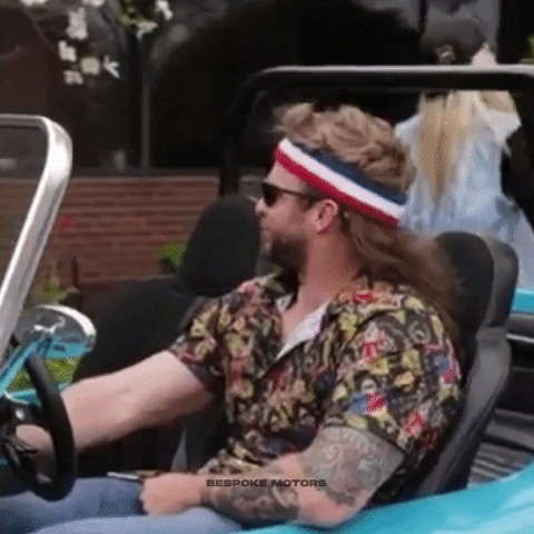 Ad gif. Man wearing a sweatband and sunglasses turns the key in teal dune buggy and smirks as he says, "Damn."