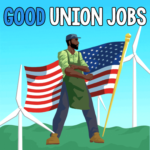 Illustrated gif. Man wearing a green apron and work boots stands in front of an American flag among spinning wind turbines. Text, "Good union jobs."