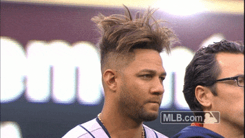 Sports gif. With his hair sticking up in an absolute mess, Yuli Gurriel of the Houston Astros gives us a side-eye.