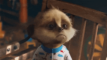 Ad gif. CGI Baby Oleg the Meerkat in pajamas draws his mouth into a pout as his big, brown eyes look up from his bed. 