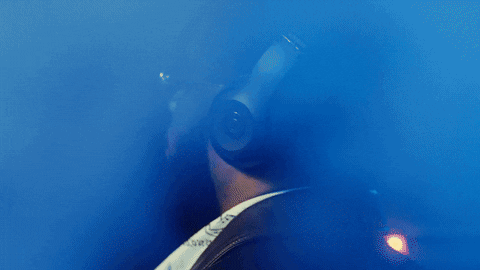 Gif of man with headphones on looking in one direction then the other.