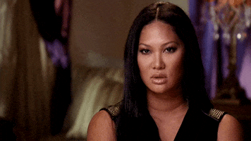 Celebrity gif. Kimora Lee Simmons tilts her head in judgment as she scowls ahead. 
