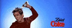 Movie gif. Ben Stiller as Zoolander pours the contents of a glass bottle over his head, pursing his lips and whipping his hair around, and the Diet Coke logo enlarges in the frame.
