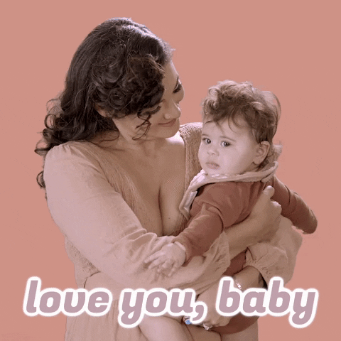 Video gif. Holding a baby to her chest, a brown-haired woman kisses the baby's forehead and then looks at the baby with admiration. Text, "Love you, baby."