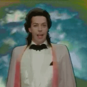 Movie gif. Tim Curry as the Grand Wizard in The Worst Witch stands in front of a cloudy animated background, turning to the side and glancing at a skeleton that creeps out from behind him.