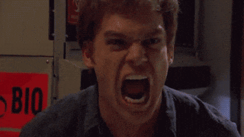 TV gif. We zoom toward an angry Michael C. Hall as Dexter as he screams in rage.