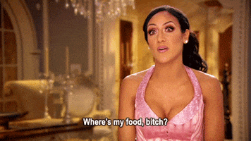Reality TV gif. Melissa Gorga on The Real Housewives of New Jersey. She's being interviewed and she looks annoyed as she asks, "Where's my food bitch."