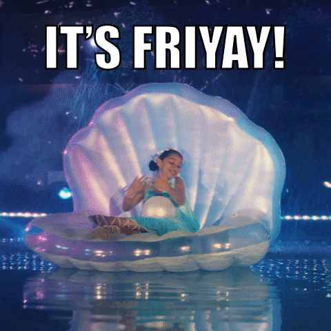 Video gif. A young woman with a giant pearl in her lap floats in a giant clam shell in a large pool, surrounded by fireworks. She raises her arms gracefully as the camera sweeps around to reveal a second person in a clam shell and four red-clad swimmers with their arms triumphantly raised. Text. "It's Friday!"