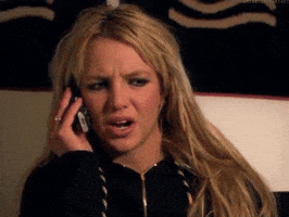 Celebrity gif. Britney Spears holds a cell phone up to her ear. She has a concerned look on her face as she listens to the other person on the phone. She then goes, “ohhh," now understanding what was said to her.
