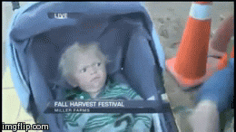 Video gif. A baby in a stroller is perceiving a situation and looks very upset and confused by it. It sinks its head in and gives a big reaction, staring and looking back at us to see if we see.