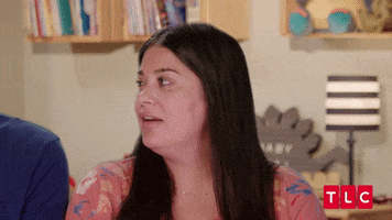 Video gif. Woman looks at us with her jaw dropped in shock. She looks around, concerned.