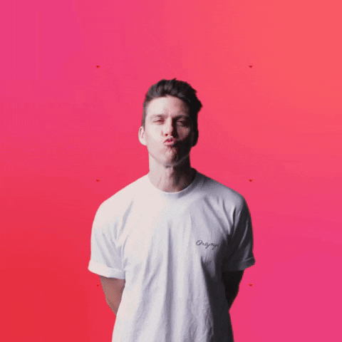 Video gif. Tomas Ferraro holds his hands behind his back and purses his lips, making an exaggerated kissy face at us against a hot pink background with pulsing red hearts. Text, "I love you."