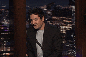 Tonight Show gif. Jimmy Fallon looks away, trying not to laugh as he swings his pointed hand in a shooing motion. He says, “Get ‘em outta here.”