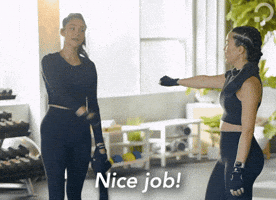 Celebrity gif. Shay Mitchell fist bumps her workout buddy saying "nice job!"