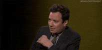 Celebrity gif. Jimmy Fallon looks a bit unsure, taking a big exaggerated breath like he's making you wait for it and then quickly says, “It is true!”
