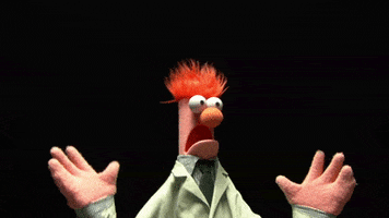 Muppets gif. Beaker trembles with horror, eyes and mouth agape and hands up by his shoulders.