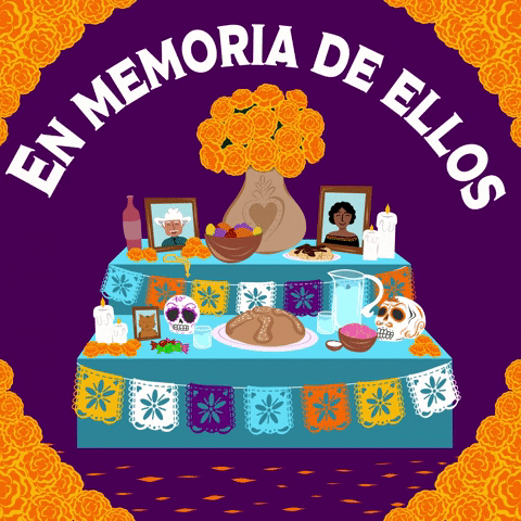 Digital illustration gif. Table set for a Day of the Dead celebration with marigolds, skulls, candles, fruit, bread, and drinks against a purple background with marigolds at each corner. Text, "En memoria de ellos."