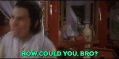 Movie gif. A man with a bloody stump for his right arm leans back with a grimace of shock and pain, looking down at his arm and then back up again. Text, "How could you, bro?"