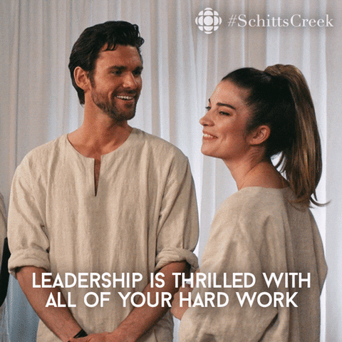 Schitt's Creek gif. Kevin McGarry as Citrus smiles kindly at Annie Murphy as Alexis, who appears gracious as he says, "leadership is thrilled with all of your hard work." 