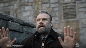 TV gif. Tyler Labine as Dr. Iggy in a dramatic low shot backs away from something slowly with a look of distress and fear on his face.