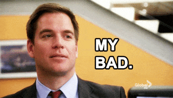 Video gif. Man in a suit acknowledges his mistake and nods while saying, "My bad."