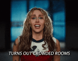 Music video gif. Miley Cyrus in her video for "Used to Be Young" sings passionately to camera. Song lyrics reads, "Turns out crowded rooms empty out as soon as there's somewhere else to go." 