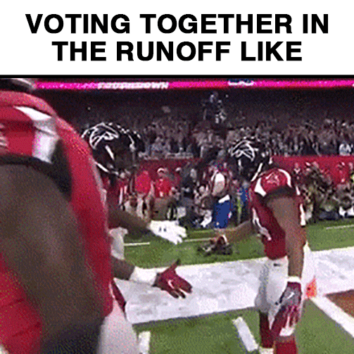 Sports gif. Atlanta Falcons cornerback AJ Terrell Junior exchanges a celebratory secret handshake with a teammate, tapping each others' helmets in a gesture of virile endearment. Text, "Voting together in the runoff like."