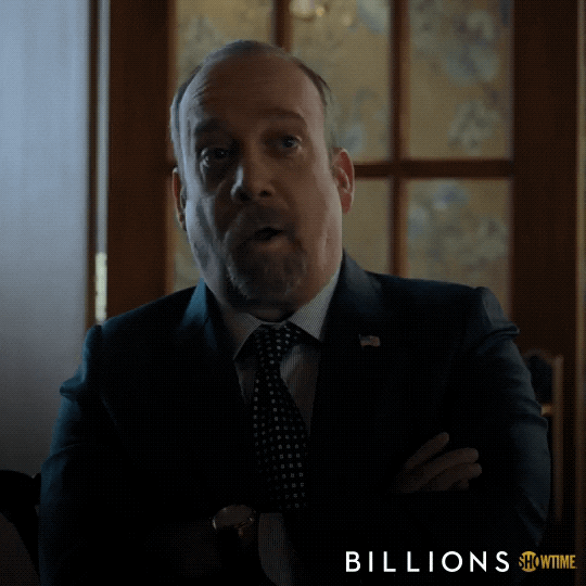 TV gif. Paul Giamatti as Chuck Rhoades from Billions gives us a sly thumbs up.