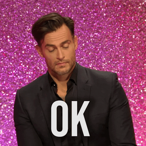 Reality TV gif. Cheyenne Jackson is guest judging on RuPaul's Drag Race and he raises his eyebrows and nods his head seriously without looking up at us and says, "Ok."