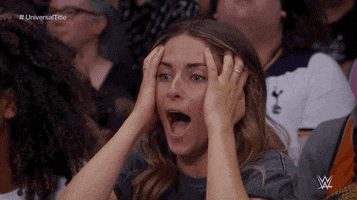 Sports gif. A young woman in the audience clutches her head and shouts in disbelief.