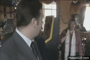 TV gif. Ricky Gervais as David on The Office UK turns toward us and shakes his head after an exchange with a woman behind him.