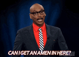 Reality TV gif. RuPaul, wearing a dark pinstripe suit over a red shirt, cocks his head and looks around. From under his mustache, he says, "Can I get an amen in here?" which also appears as text.