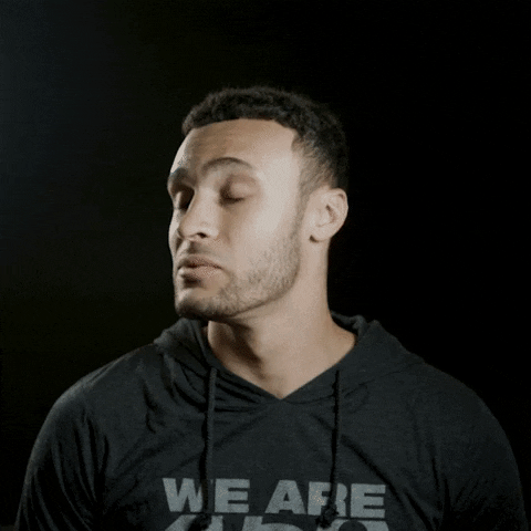 Celebrity gif. Basketball player Larry Nance Jr. reacts to something shocking with wide eyes and jumps back, putting a hang over his mouth. Text, “Dang!”