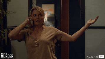 TV gif. Lucy Lawless as Alexa in My Life Is Murder leans against a wall holding her phone to her ear while she spreads her arm out and looks incredulously, mouth ajar and looking side to side.