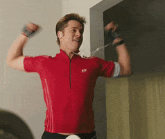 Movie gif. Brad Pitt as Chad in Burn After Reading wears a slightly small runner shirt and has earbuds in his ears. He dances, pumping his arms and moving hips. He bites his lip and moves his head side to side.