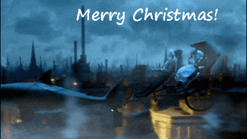 TV gif. In a Christmas episode of Doctor Who, three people wearing Santa hats fly in a shark-led carriage over the city. Text, “Merry Christmas!”