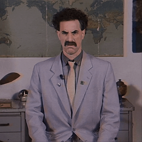 Movie gif. Sacha Baron Cohen as Borat leans against some filing cabinets in front of a large world map, shaking his head back and forth with a disgusted expression on his face as if to say, "No way!"
