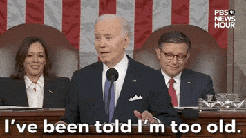 Political gif. Joe Biden stands at a podium during the State of the Union address. He grins and opens his eyes wide as he says, “I've been told I'm too old.”