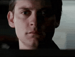 Movie gif. Three quick zoom-ins on Tobey Maguire's face as he sheds a single tear.